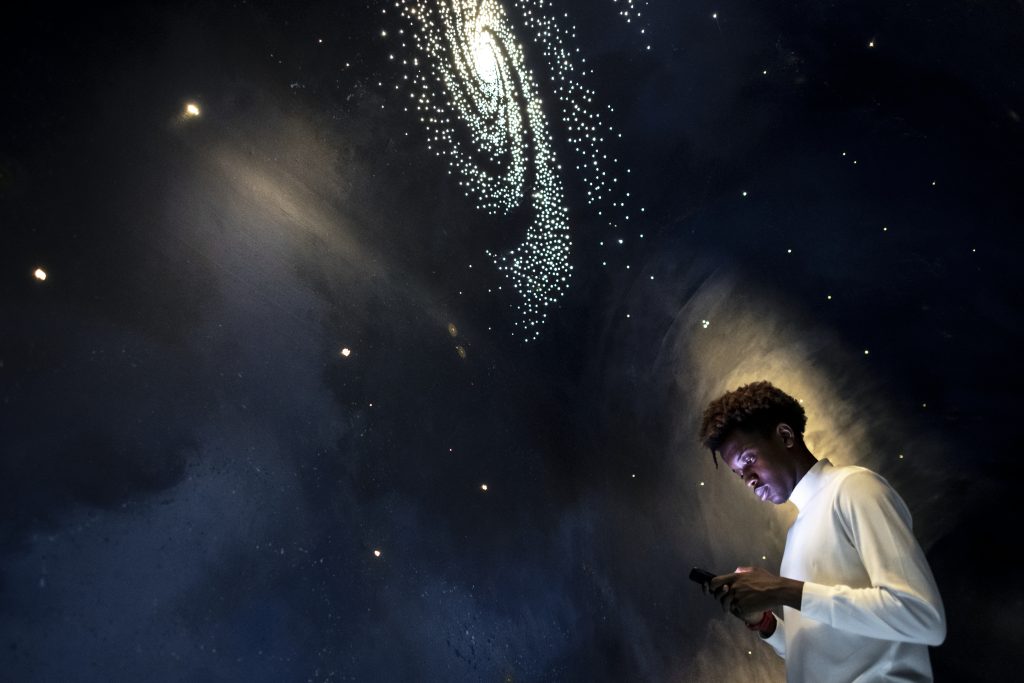 man experiencing the universe at a planetarium