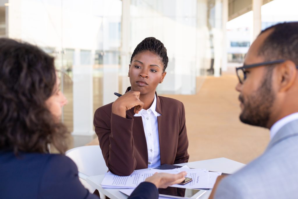 Choosing a Counsellor: Questions to Ask Before Your First Session Multiethnic Business Partners Discussing Contract Terms 1024x683