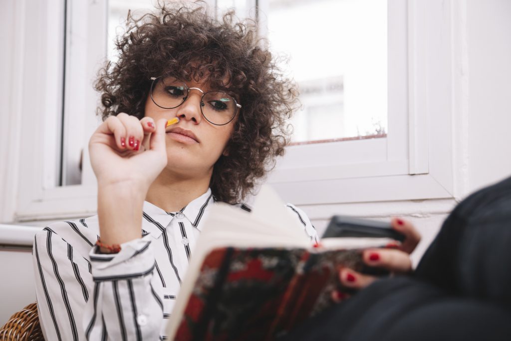 thinking teenager making notes
